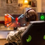 back view gamer male playing shooter