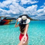 bikini girl holding man s hand leading him ocean krabi thailand