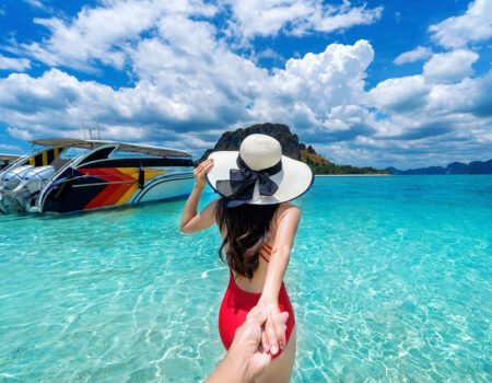 bikini girl holding man s hand leading him ocean krabi thailand
