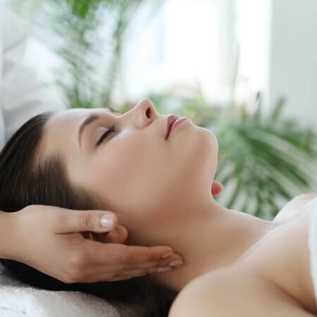 lying woman receiving massage craniosacral therapy