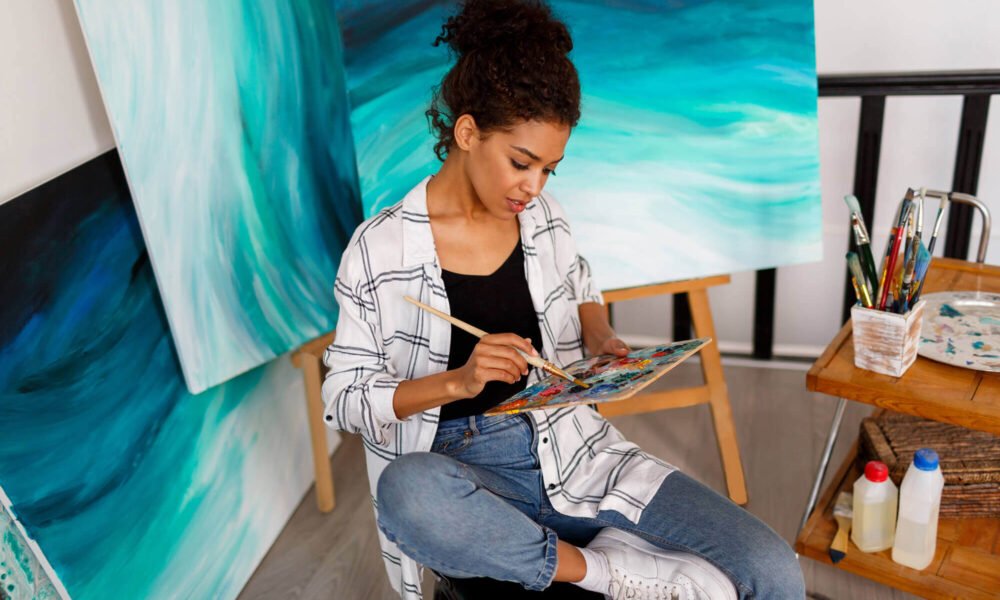 professional female artist painting canvas studio