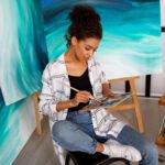 professional female artist painting canvas studio