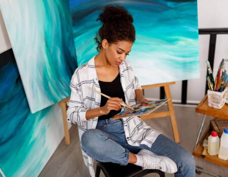 professional female artist painting canvas studio