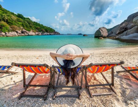 woman with hat sitting chairs beach beautiful